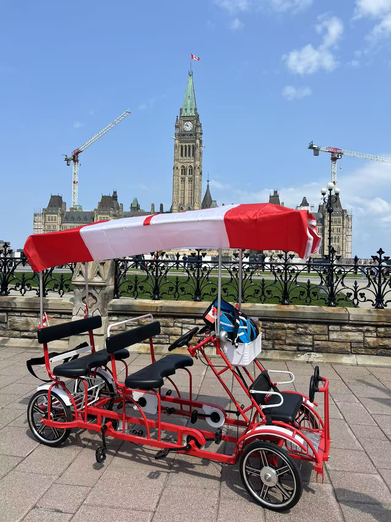 Double Row Surrey Bike — The Explorer, with Canadian flag canopy in front of Parliament Hill