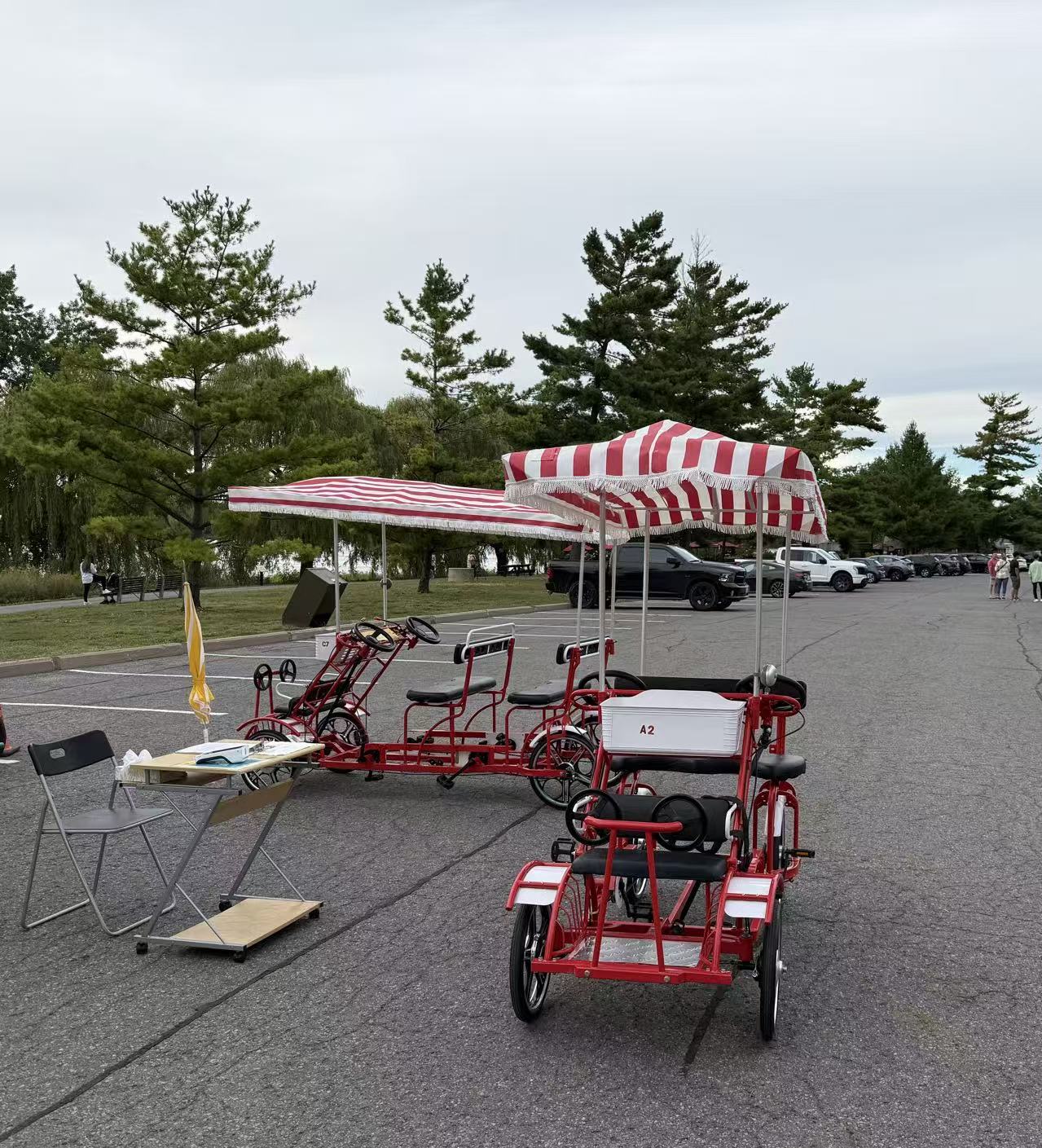 Single Row Surrey Bike — The Cruiser, with red and white striped canopy at Remic Rapids Park