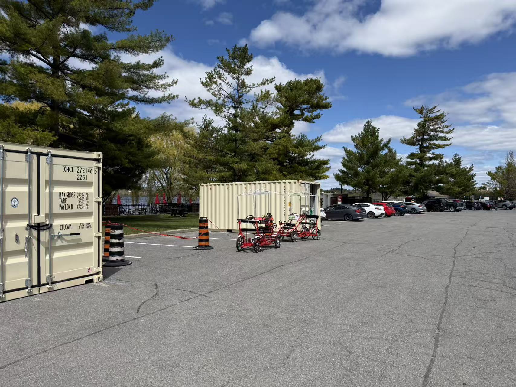 Telicity Surrey Bike rental site at Remic Rapids Park — shipping container station and parked bikes by the Ottawa River